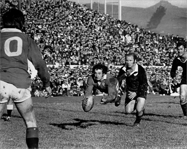 Gareth Edwards passes to Barry John during the second Lions test against the All Blacks in 1971 (crop)