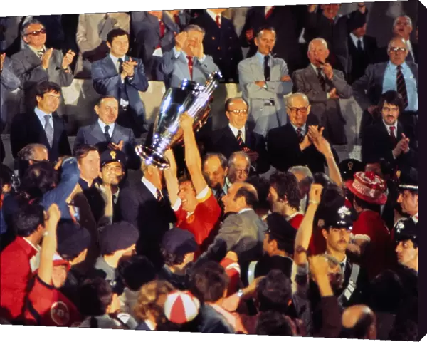 Liverpool captain Emlyn Hughes lifts the European Cup in 1977
