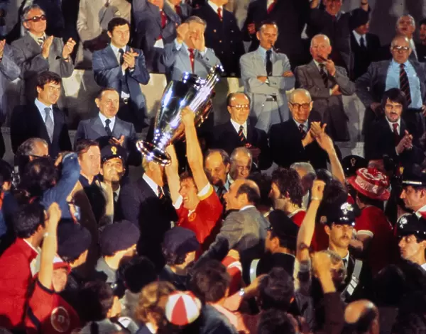 Liverpool captain Emlyn Hughes lifts the European Cup in 1977