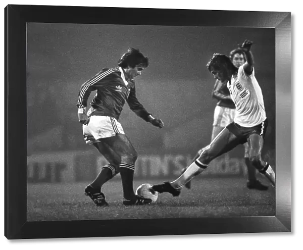 Glenn Hoddle attempts to tackle George Best