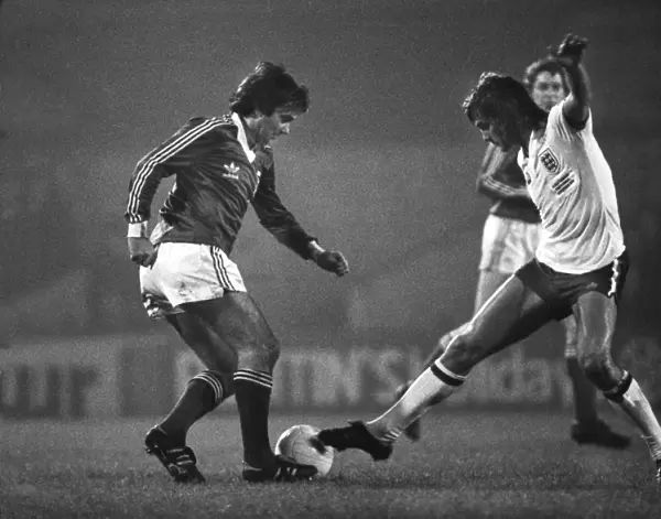 Glenn Hoddle attempts to tackle George Best