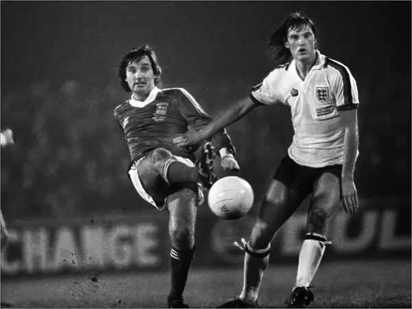 George Best passes the ball as he is challenged by Glenn Hoddle
