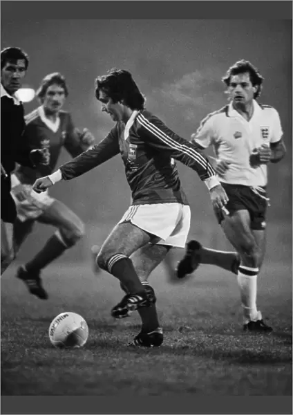 George Best on the ball for Ipswich while Englands Ray Wilkins looks on