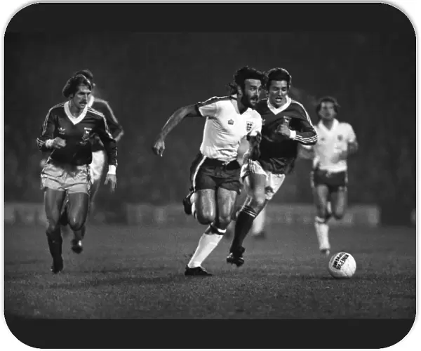Ricky Villa sprints on the ball while playing for an England XI in 1979