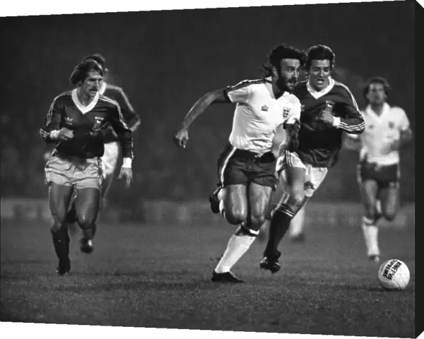 Ricky Villa sprints on the ball while playing for an England XI in 1979