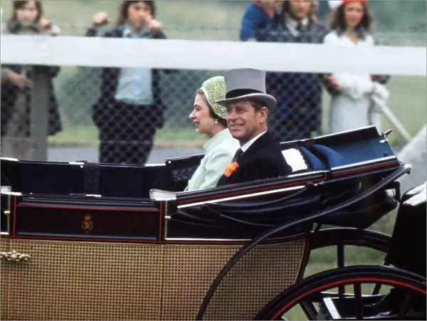 The Queen and Prince Phillip arrive at the races in the Royal Carriage, 1973