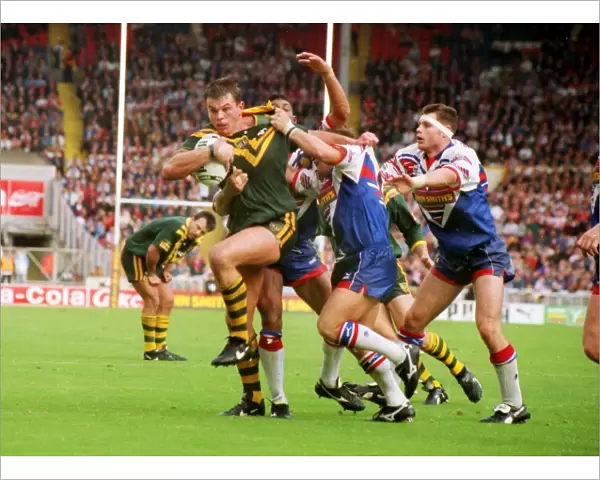 Australias Paul Harragon is tackled by several Great Britain defenders