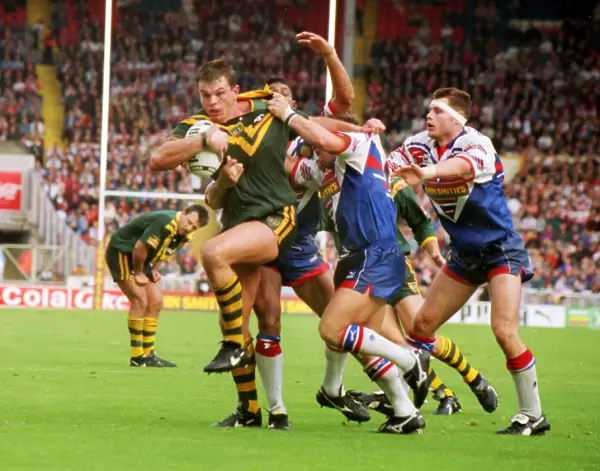 Australias Paul Harragon is tackled by several Great Britain defenders