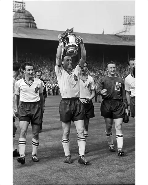 Bolton captain Nat Lofthouse parades the trophy after victory in the 1958 FA Cup Final