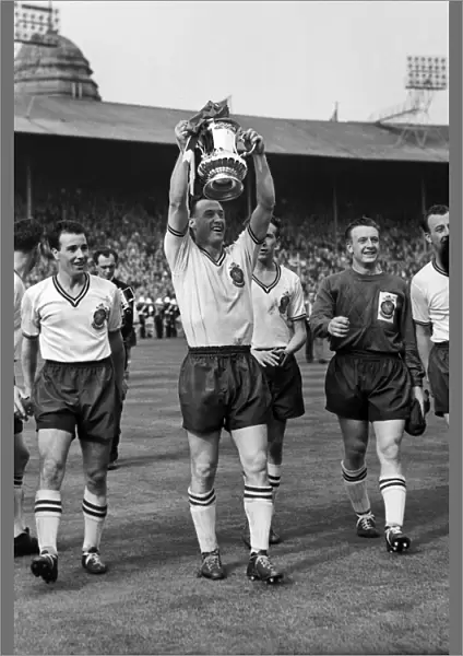 Bolton captain Nat Lofthouse parades the trophy after victory in the 1958 FA Cup Final