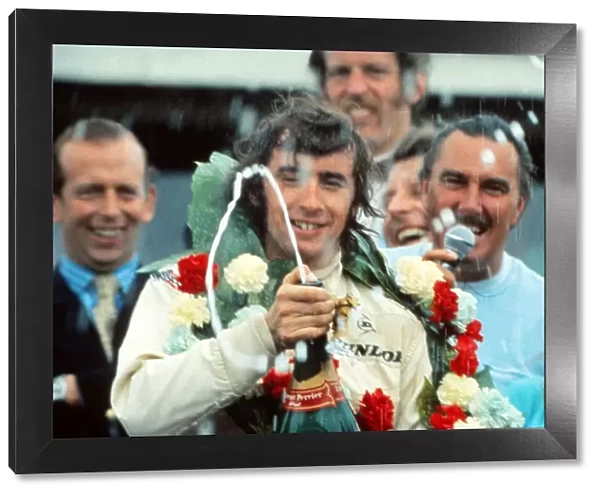Jackie Stewart celebrates winning the 1969 British Grand Prix