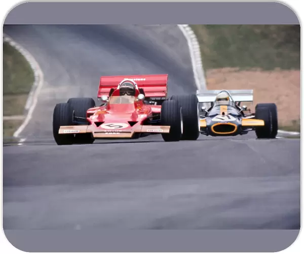 Jochen Rindt and Jack Brabham approach Druids at the 1970 British Grand Prix at Brands Hatch