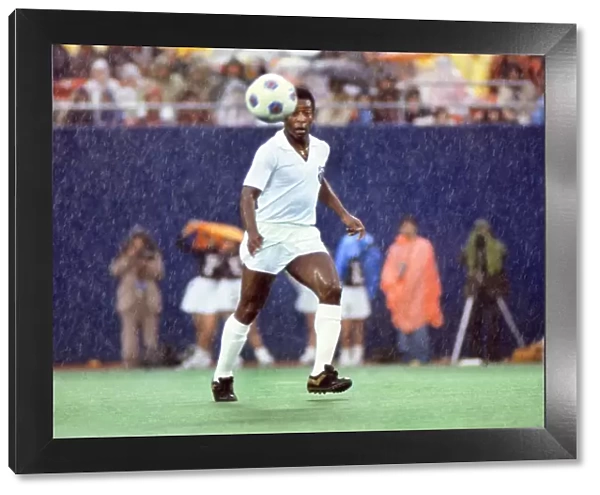 Pele playing for Santos in the rain during his farewell game in 1977