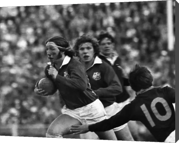 A bloody JPR Williams makes a break for the British Lions