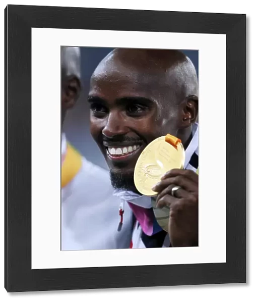 Mo Farah shows of his 5000m gold medal