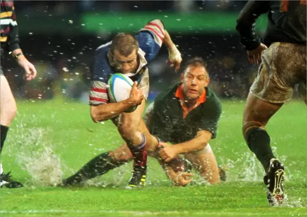 Fabien Galthie attempts to make a break in the rain-soaked 1995 Rugby World Cup semi-final