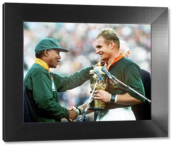 South Africa captain Francois Pienaar receives the World Cup from Nelson Mandela in 1995