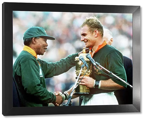 South Africa captain Francois Pienaar receives the World Cup from Nelson Mandela in 1995