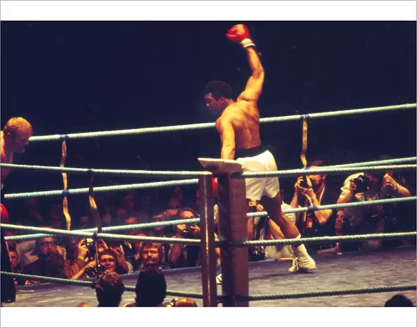 Muhammad Ali show off to the crowd as he knocks down Richard Dunn