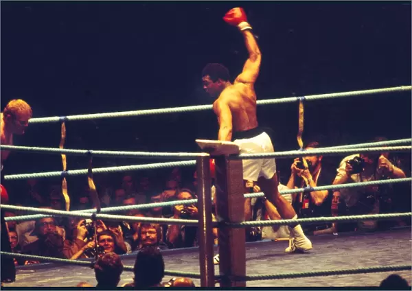 Muhammad Ali show off to the crowd as he knocks down Richard Dunn