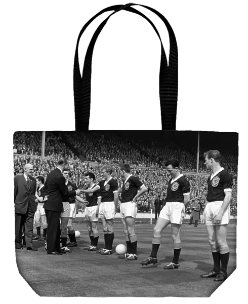 Prince Phillip shakes hands with Denis Law during the 1961 Home Championship