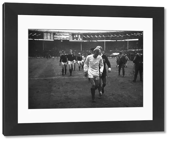 Scotlands Denis Law, wearing Bobby Charltons England shirt, walks off the Wembley pitch in 1965