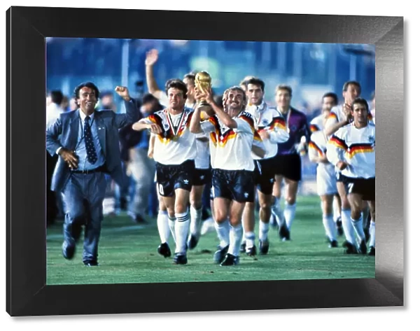 Rudi Voller celebrates with the World Cup trophy in 1990