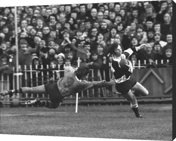 JJ Williams evades a tackle to score for the Barbarians in 1976