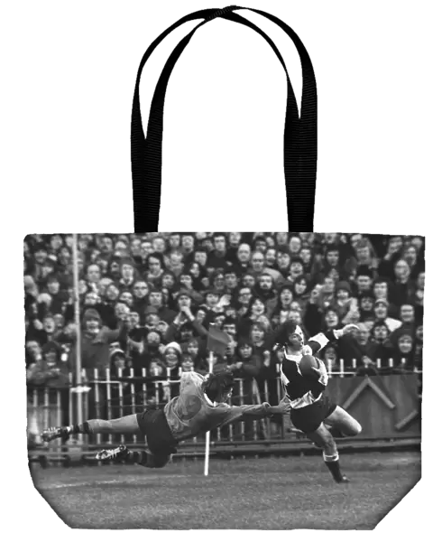 JJ Williams evades a tackle to score for the Barbarians in 1976