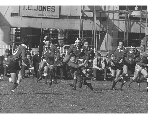 Gareth Edwards passes the ball out to Barry John at Cardiff Arms Park in 1969