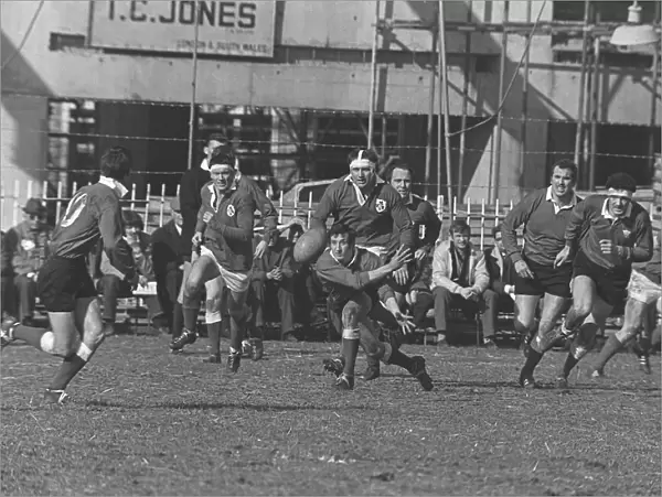Gareth Edwards passes the ball out to Barry John at Cardiff Arms Park in 1969