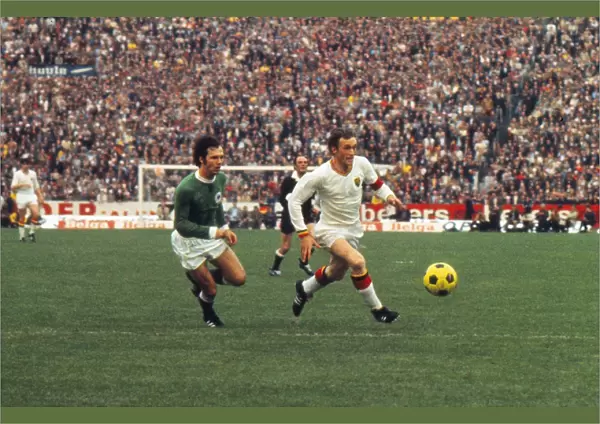 Franz Beckenbauer and Paul Van Himst run for the ball at Euro 72