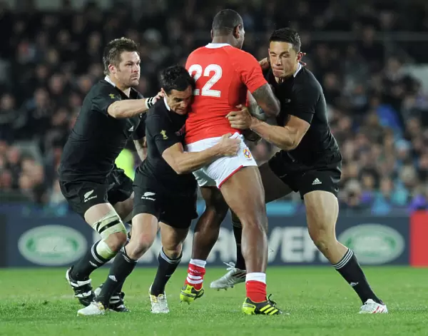 Richie McCaw, Dan Carter, and Sonny Bill Williams make a tackle at the 2011 Rugby World Cup