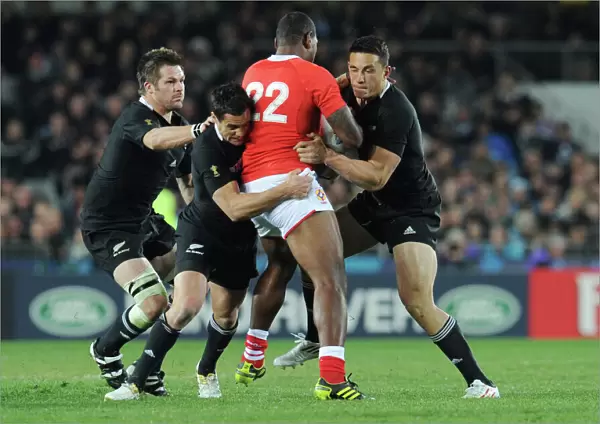 Richie McCaw, Dan Carter, and Sonny Bill Williams make a tackle at the 2011 Rugby World Cup
