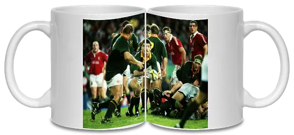 South Africas Joost van der Westhuizen passes the ball out against the British Lions in 1997