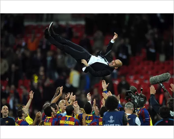 Pep Guardiola is thrown in the air by his team at Wembley after victory in the Champions League Final