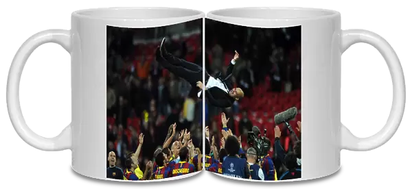 Pep Guardiola is thrown in the air by his team at Wembley after victory in the Champions League Final