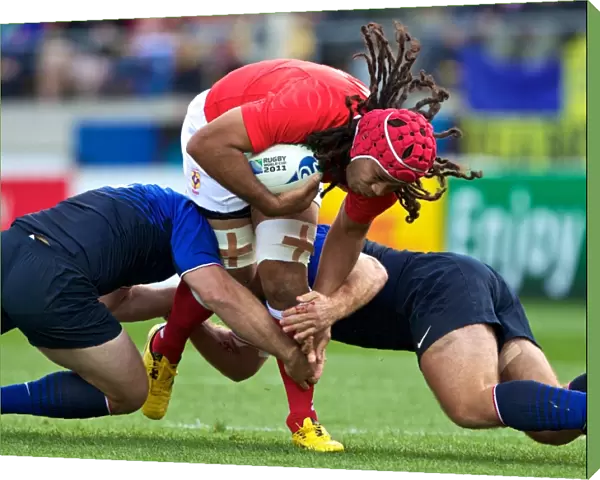 Tongas Paino Hehea is tackled by French defenders at the World Cup