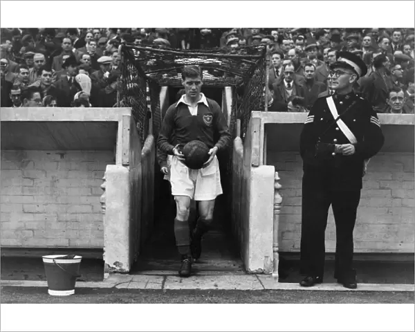 Portsmouth captain Jimmy Dickinson leads his side out at Fratton Park in 1955