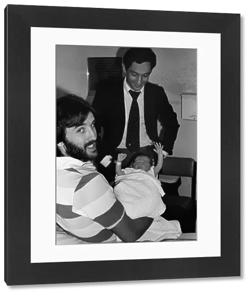 Ricky Villa holds his new baby, as Tottenham team mate Ossie Ardiles comes to visit the child at Chase Farm Hospital, Enfield