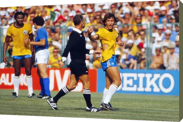 Brazils Zico remonstrates with the referee after his shirt is ripped at the 1982 World Cup