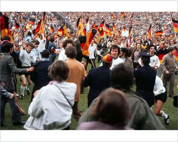 West German players run of the field as fans invade the pitch after victory in Euro 72