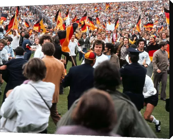 West German players run of the field as fans invade the pitch after victory in Euro 72