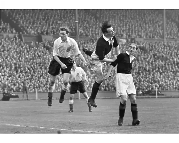 Tom Finney heads the ball against Scotland during the 1953 British Home Championship
