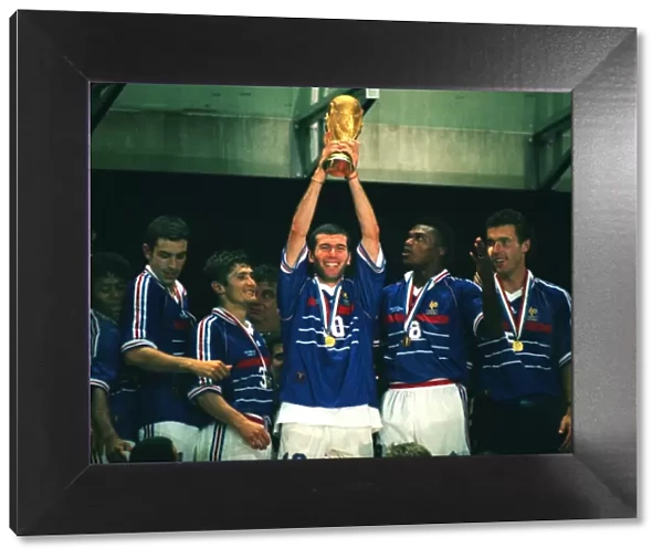 Man of the Match Zinedine Zidane holds aloft the World Cup trophy