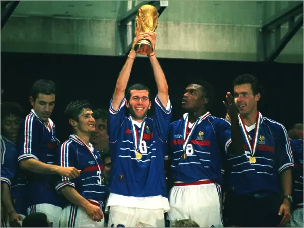 Man of the Match Zinedine Zidane holds aloft the World Cup trophy