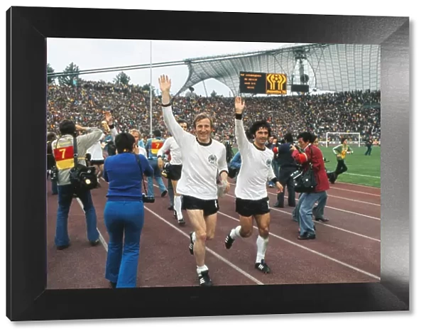 West Germanys Hans-Georg Schwarzenbeck and Gerd Muller go on a lap of honour after winning the 1974 World Cup