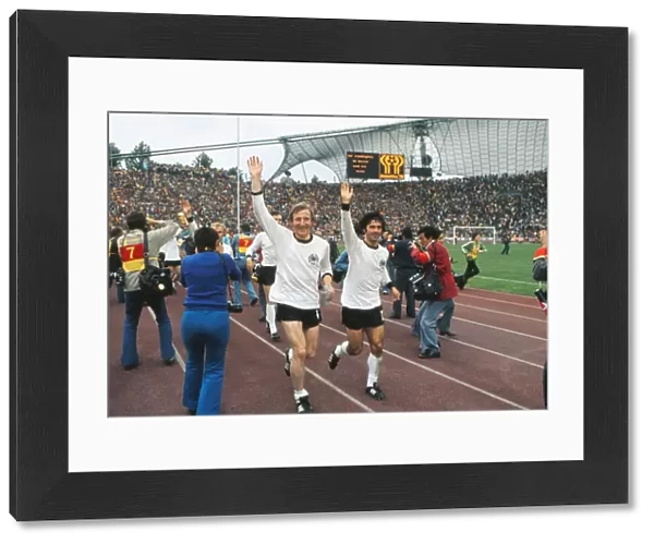 West Germanys Hans-Georg Schwarzenbeck and Gerd Muller go on a lap of honour after winning the 1974 World Cup