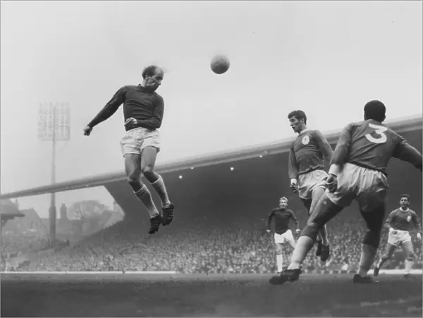 Bobby Charlton leaps to head the ball in the 1964  /  5 season
