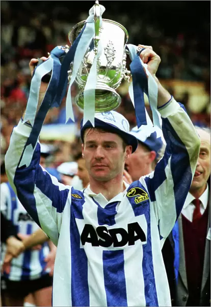Sheffield Wednesday goalscorer John Sheridan holds aloft the League Cup trophy in 1991